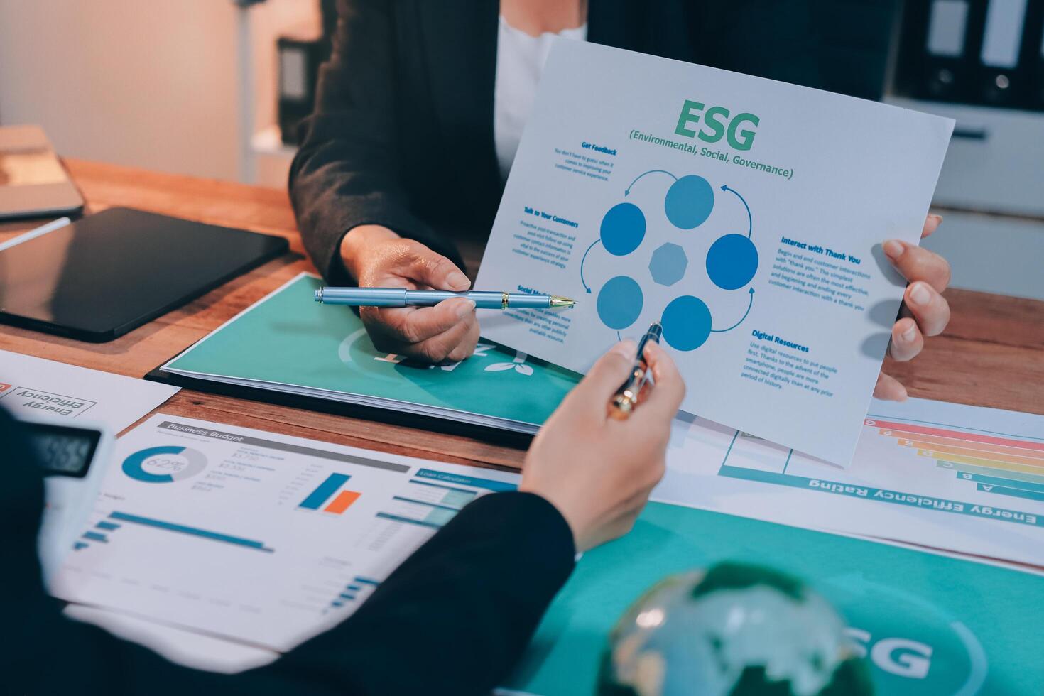 Two people are working on a paper with the words eeg on it photo