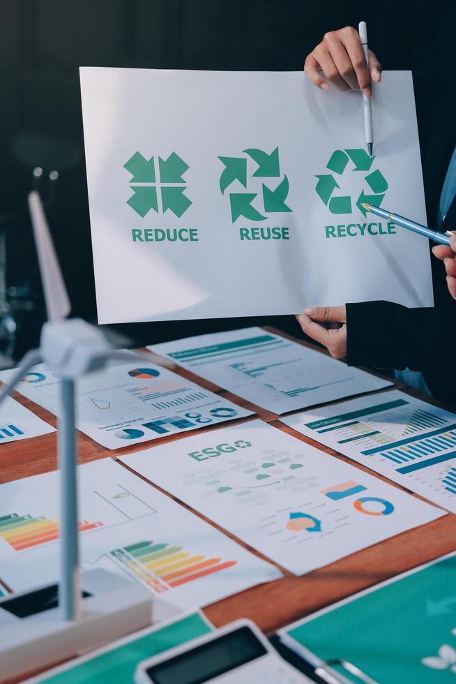 A man holding a paper with the words recycle and recycle on it photo