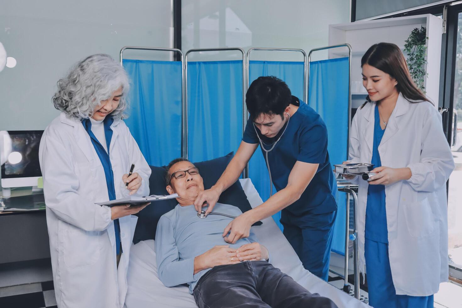 A group of doctors and nurses standing around a patient photo