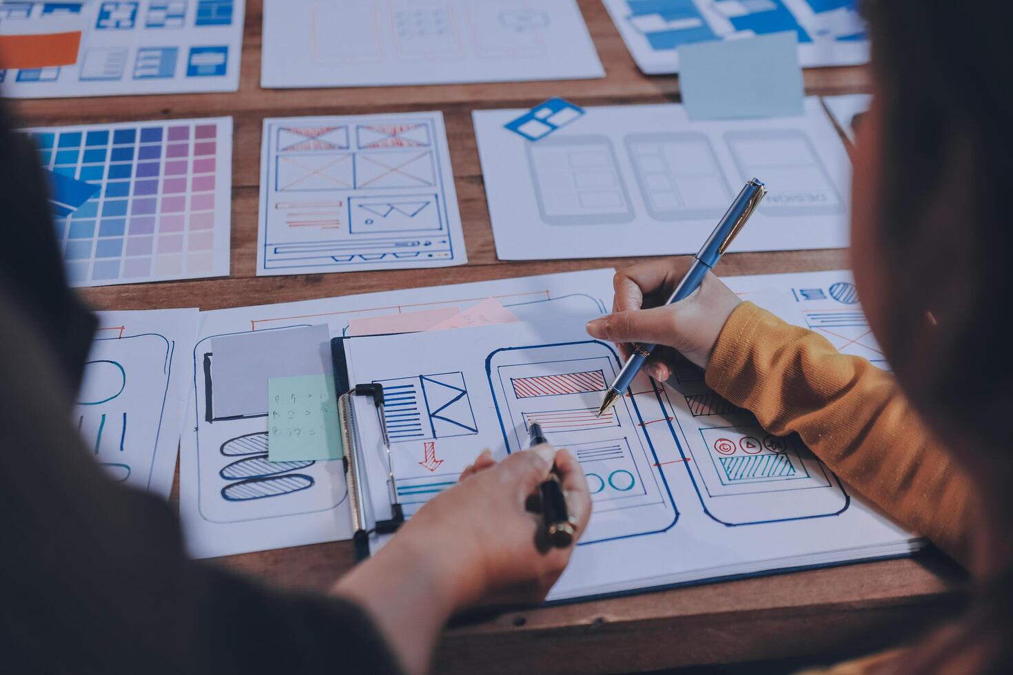 A person is working on a design project on a table photo
