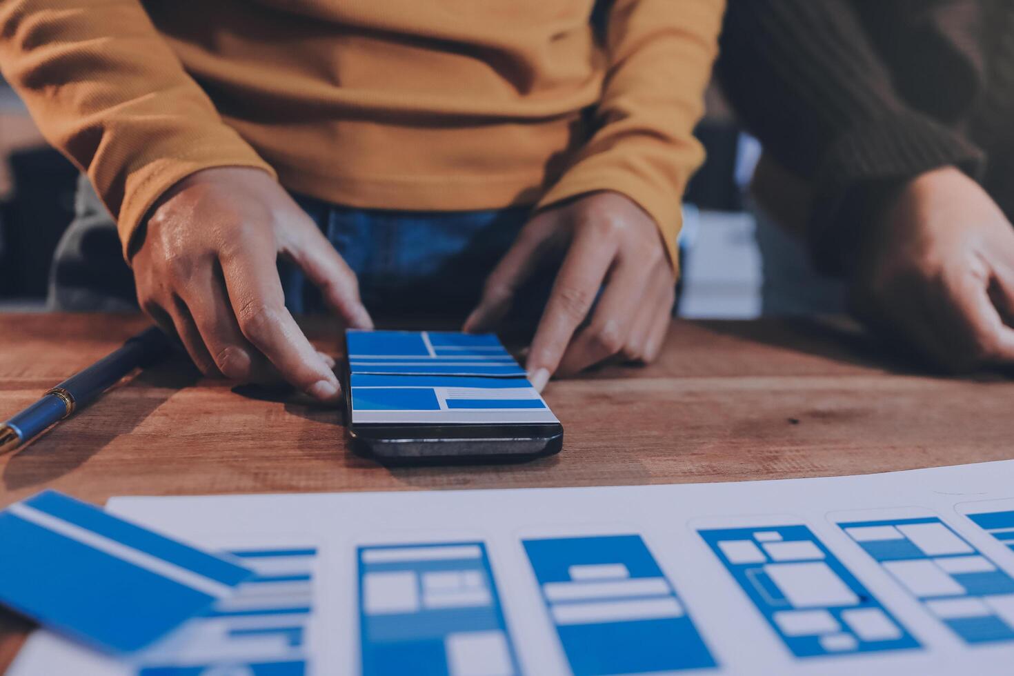 Two people are working on a blue and white design photo