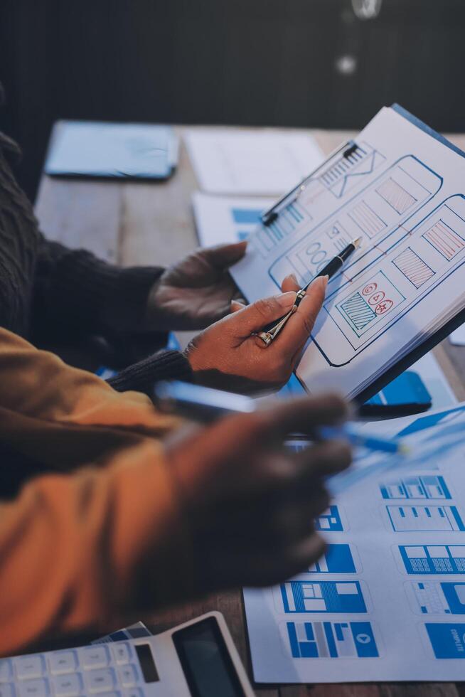 Two people working on a project on a table photo