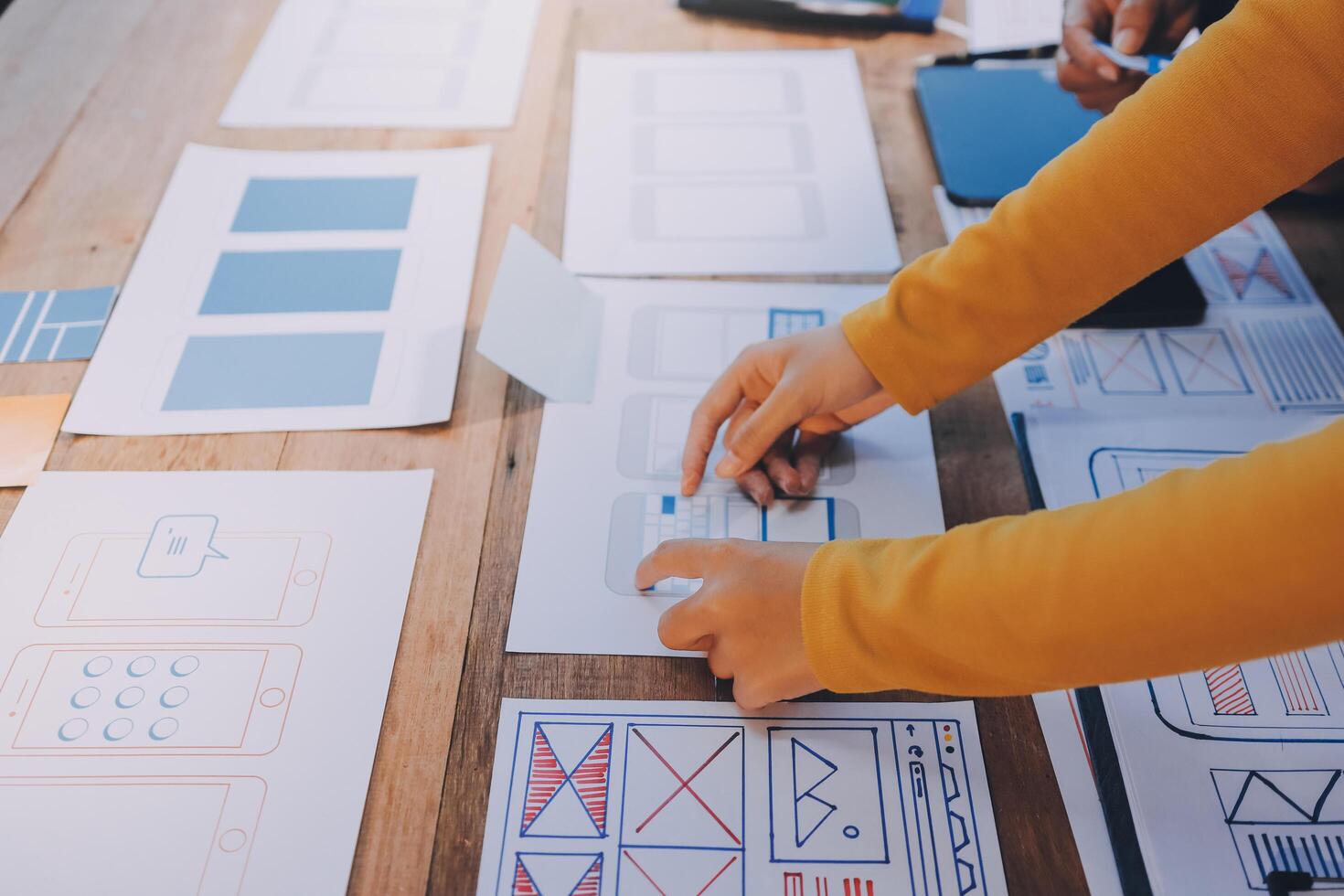A person is working on a design project on a table photo
