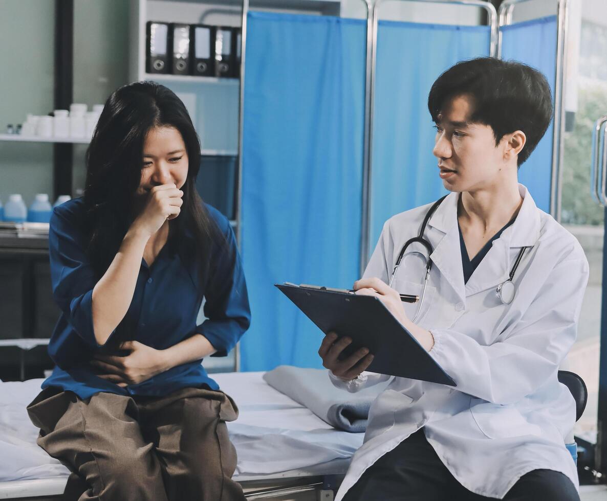A doctor is talking to a woman in a hospital bed photo