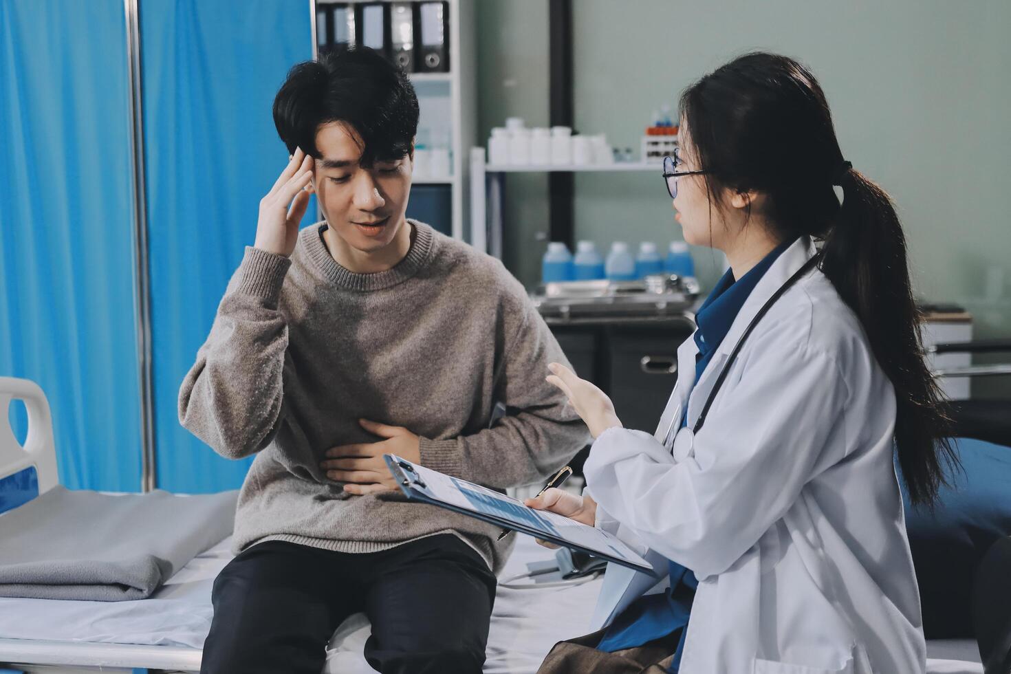 A doctor talking to a patient in a hospital bed photo