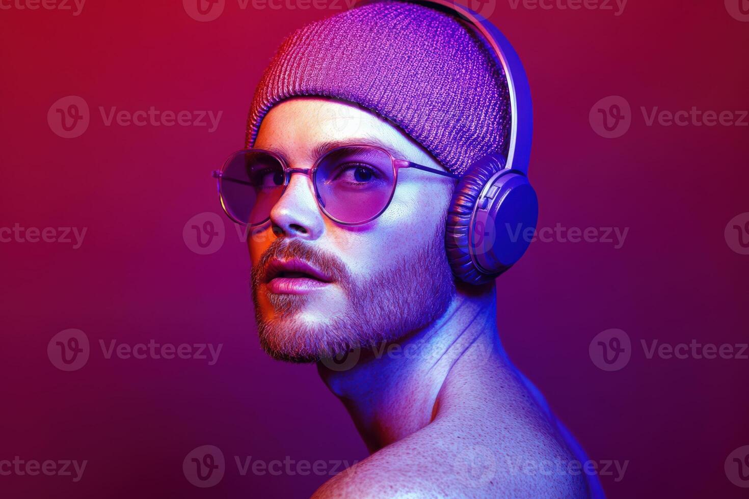 Stylish man wearing headphones and sunglasses against a vibrant background photo