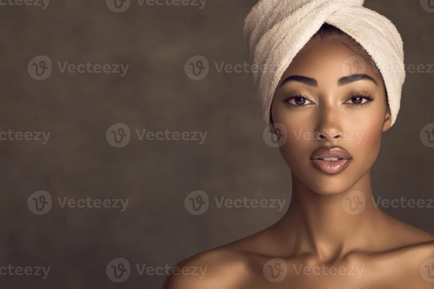 Woman with a towel on her head, showcasing natural beauty and skincare photo