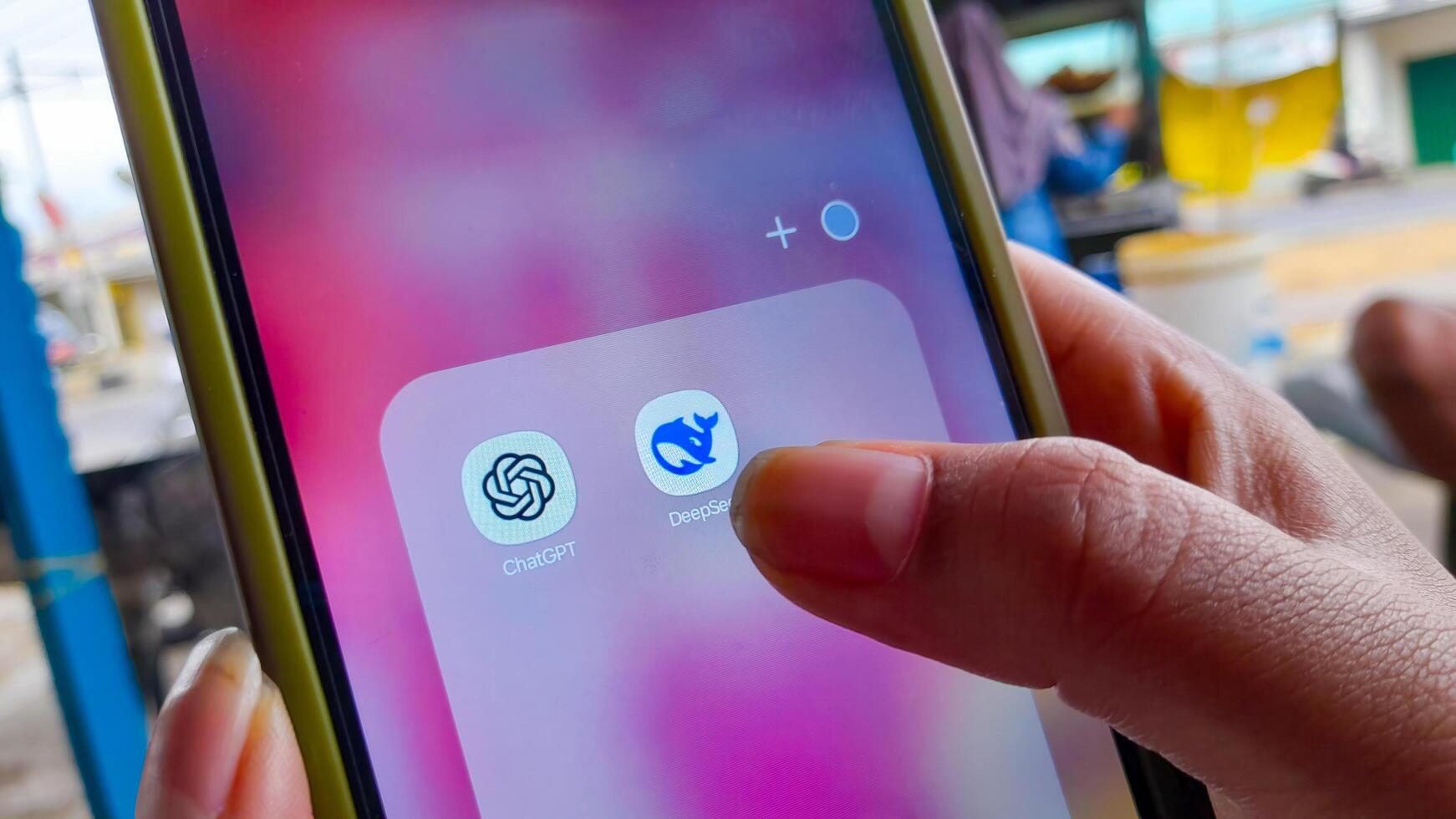 Close up of Hand Holding Smartphone with ChatGPT and DeepSeek AI Applications on a Screen. Bandung, Indonesia, February 04, 2025. photo