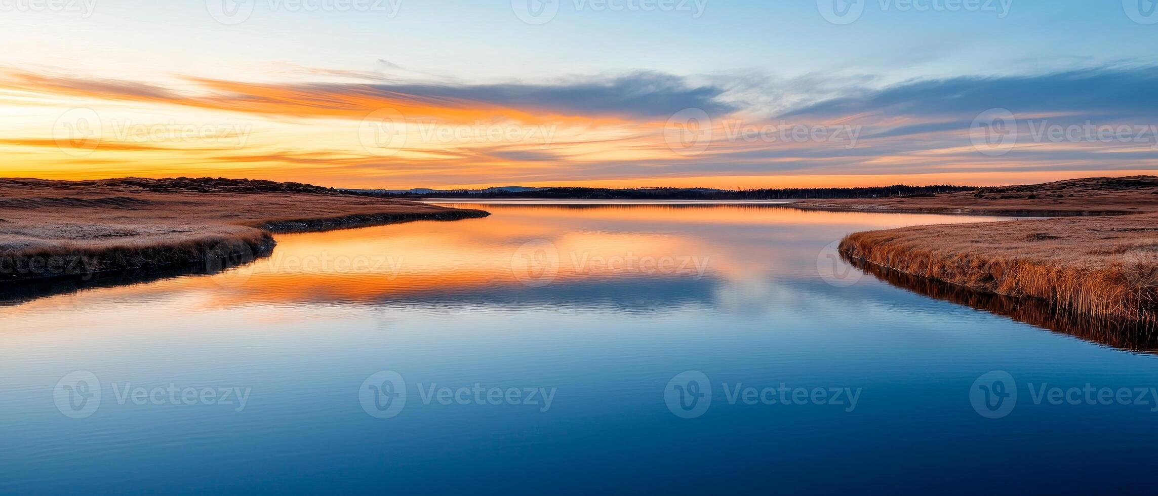 Burnout recovery mental concept. Tranquil river reflecting a colorful sunset over the horizon. photo