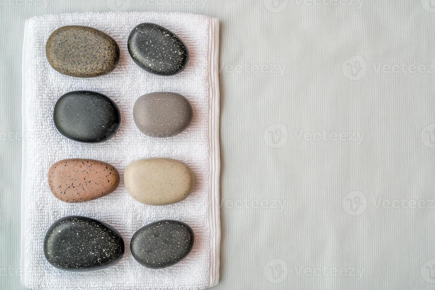 Burnout recovery stress concept. Smooth stones arranged on a cloth against a textured background. photo