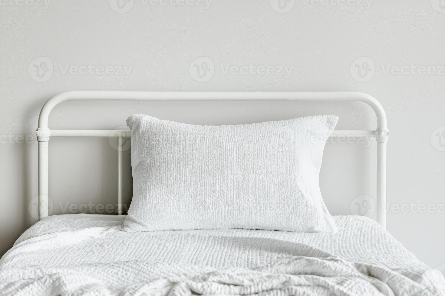 Burnout recovery mental concept. Minimalist bed with white bedding and a textured pillow against a neutral wall. photo