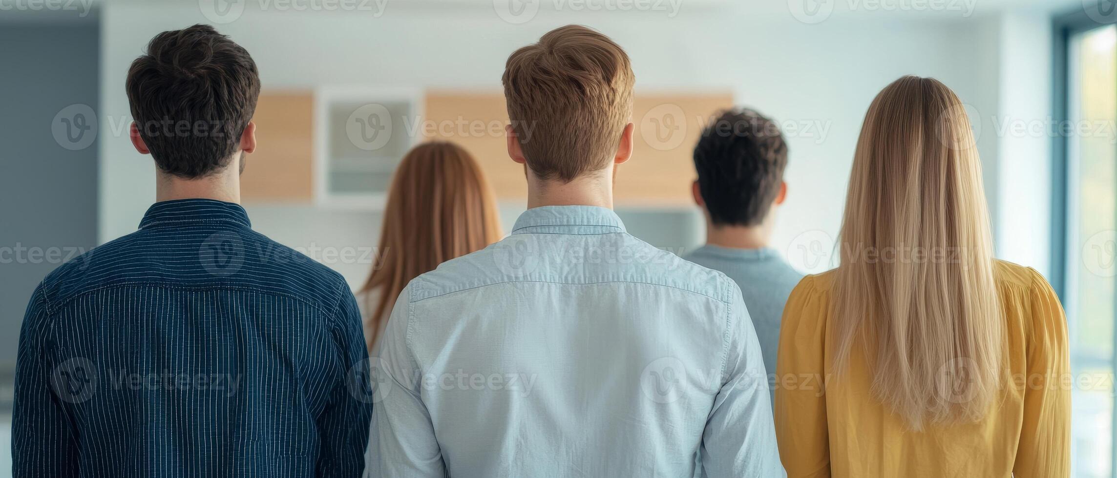 Group of people viewed from behind in a modern setting. photo