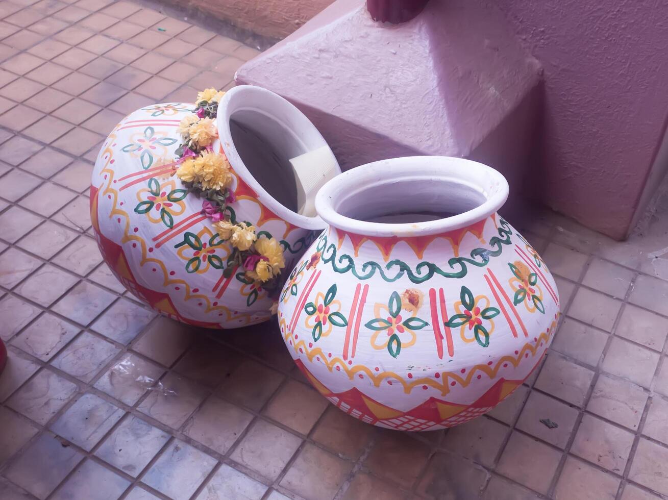 Colorful traditional painted clay pots with bright floral decorations and details photo
