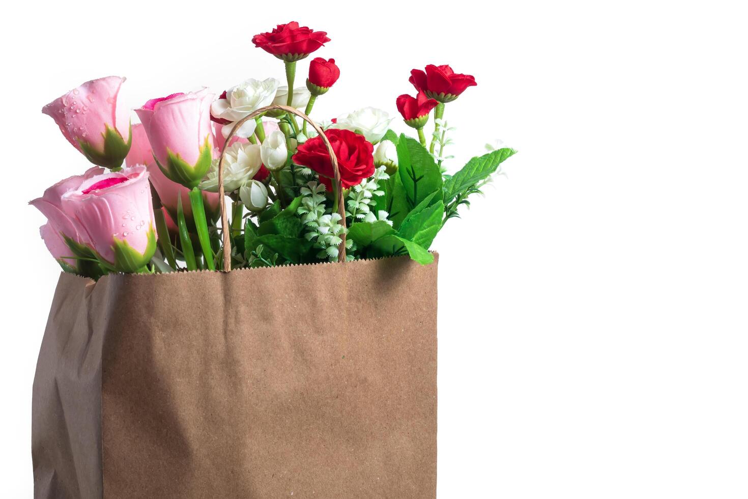 Fresh bouquet of flowers in a paper bag with white background. Perfect for natural and gift themed projects photo