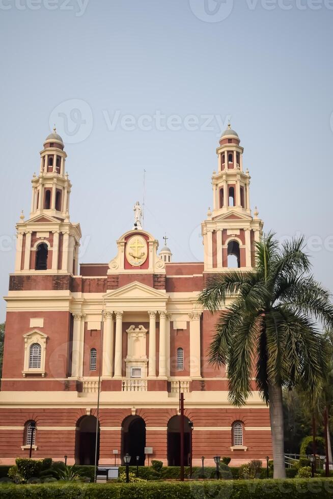 A large red brick building with two towers photo