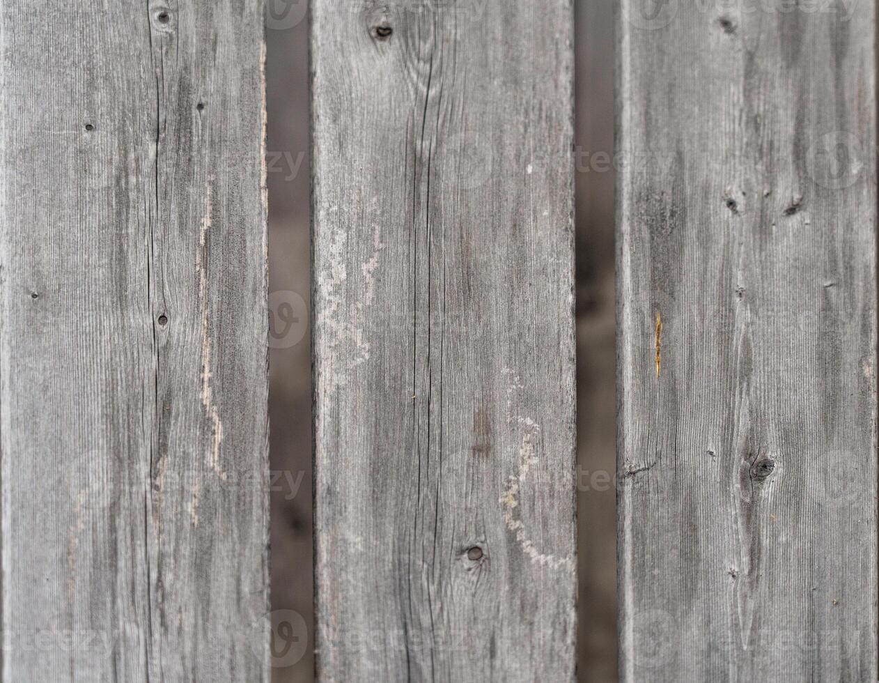 Weathered gray wooden planks, showing age and texture. photo