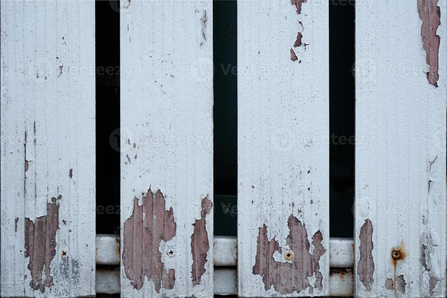 Close-up of weathered, peeling paint on wooden planks. photo