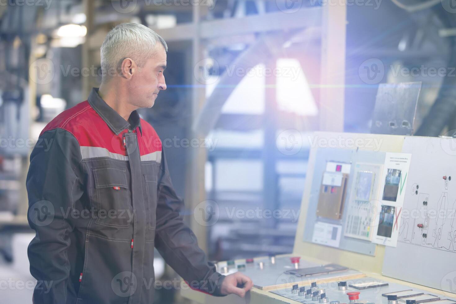 A worker at an enterprise at a computer-controlled machine. photo