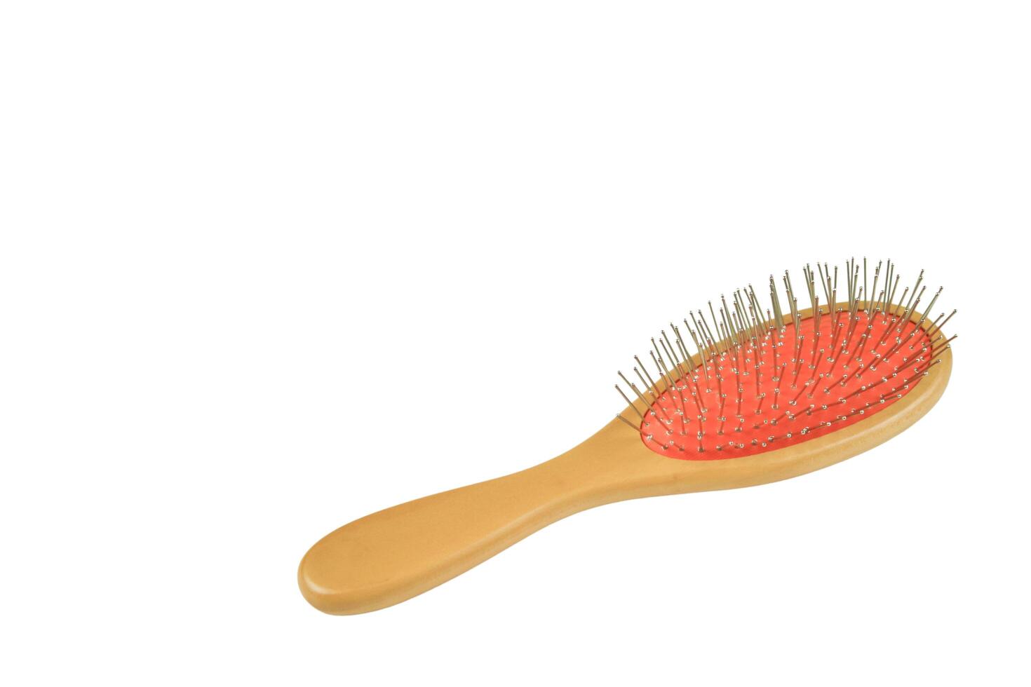 A classic hairbrush with metal bristles and a wooden handle is cut out with clipping paths on white background. photo