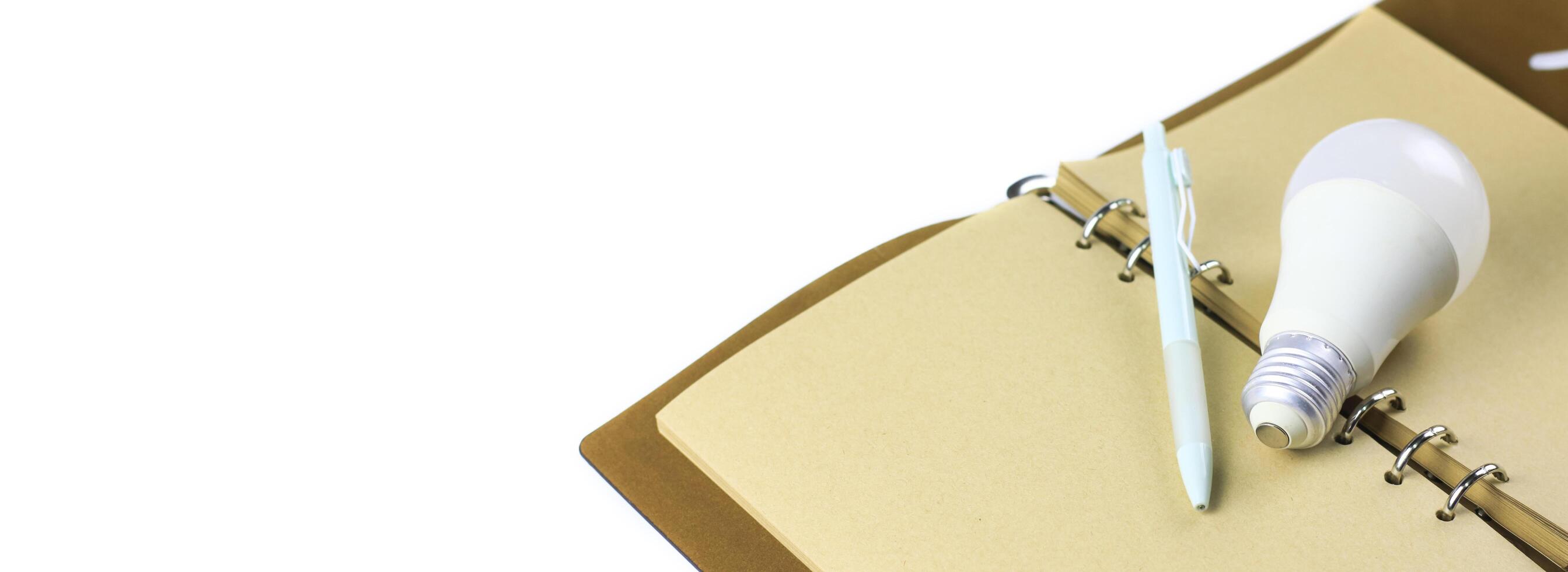 Light bulb on an open notebook, symbolizing creativity, innovation, inspiration and new ideas. photo