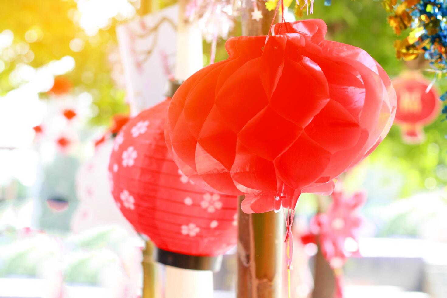 Bright red paper lanterns hanging beautifully as part of Chinese New Year decorations, symbolizing prosperity, good fortune, and happiness. photo