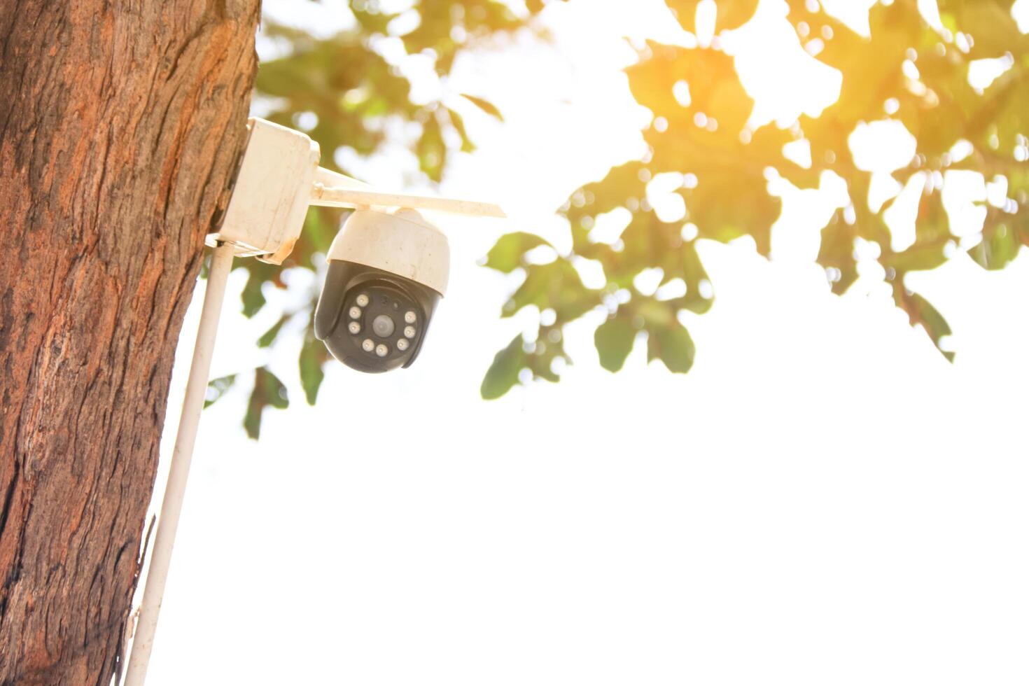 Old reliable CCTV camera mounted outdoors, exposed to sun and rain over the years, standing guard to ensure security for homes. Symbol of safety and modern surveillance technology. photo