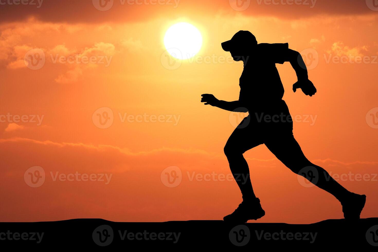 Silhouette of a Runner Against a Vibrant Sunset Sky in a Scenic Outdoor Setting photo
