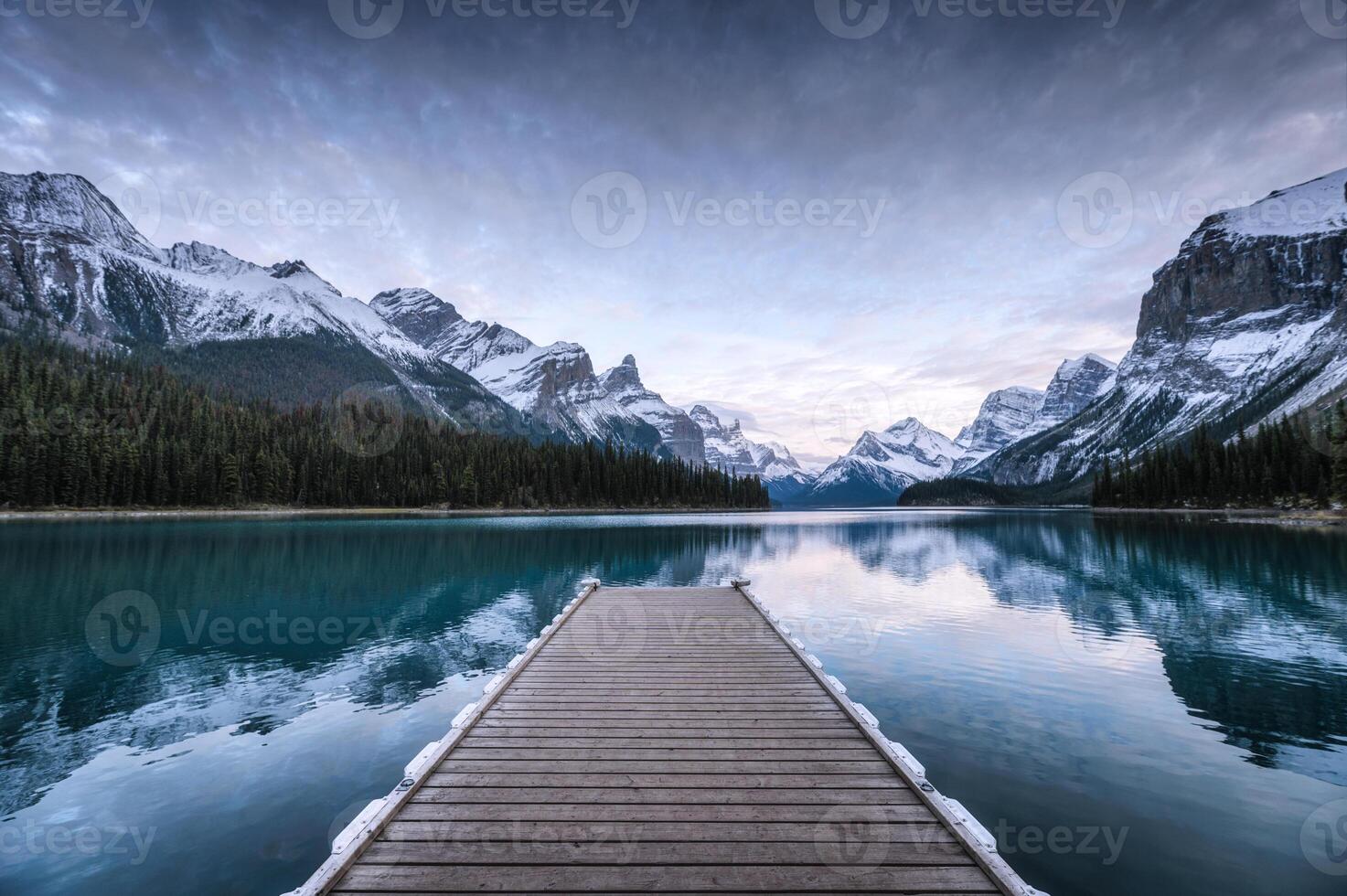 Spirit Island with wooden pier and Canadian Rockies on Maligne lake at Jasper national park, Canada photo