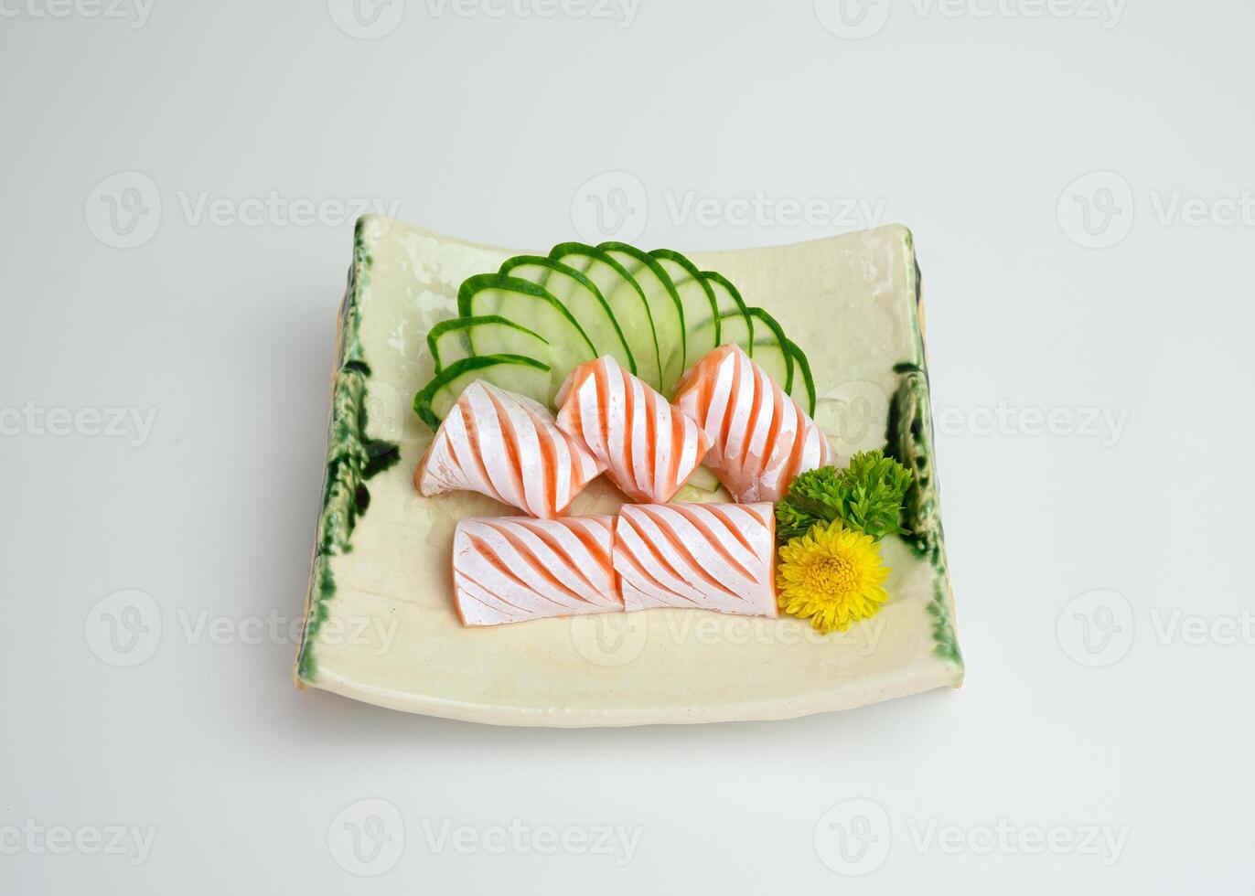 Sliced raw Salmon sac sashimi with cucumber on plate photo