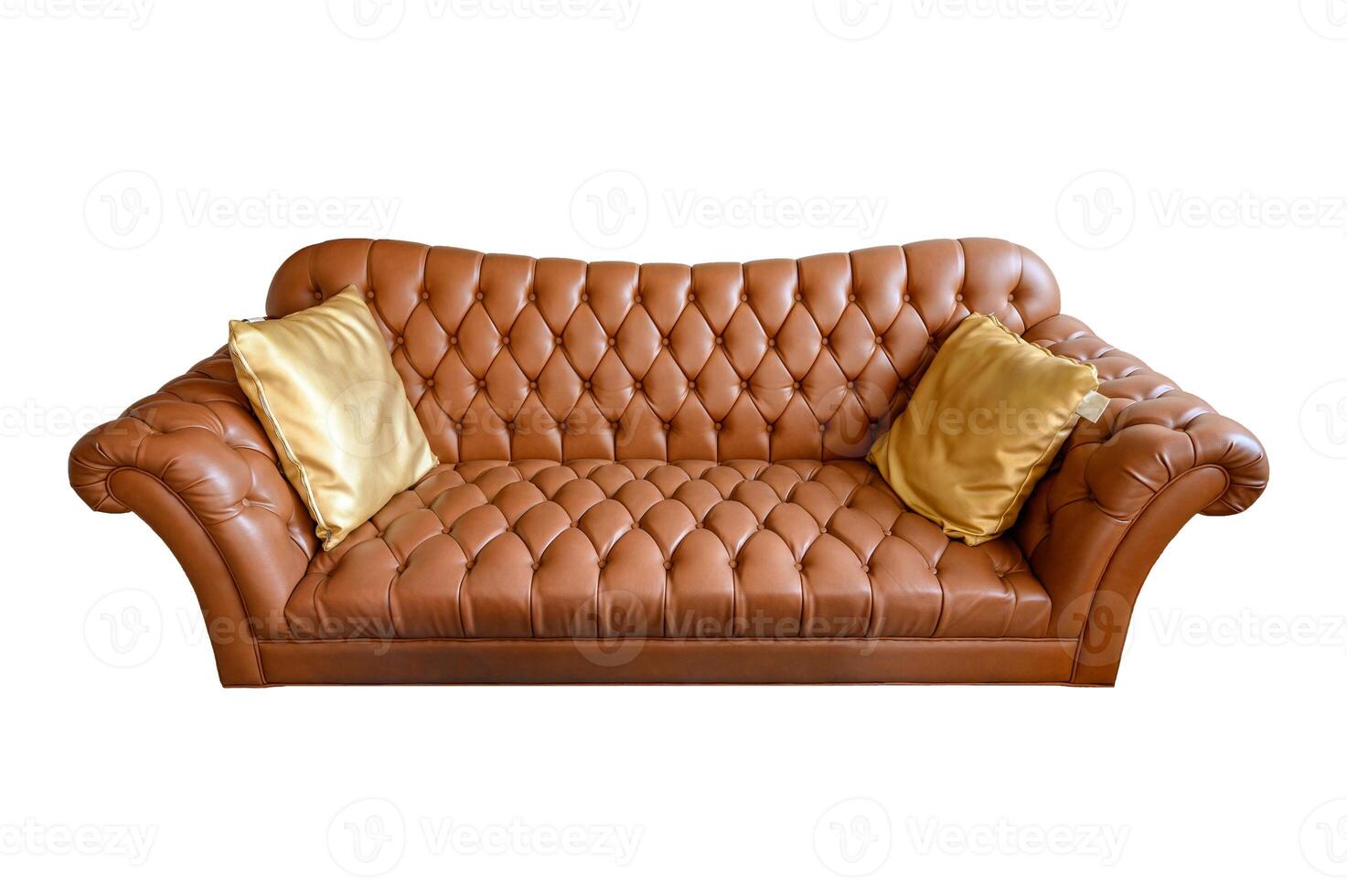 Orange vintage leather sofa buttoned with golden pillows. Isolated on background photo