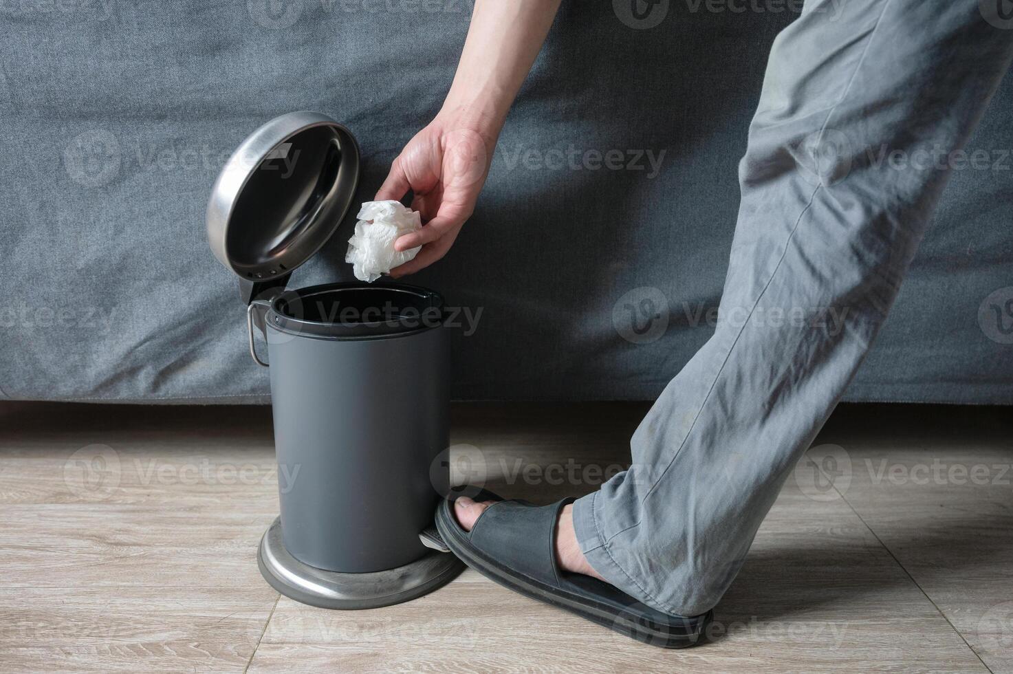 Man opening and discarded wrinkled paper in bin photo