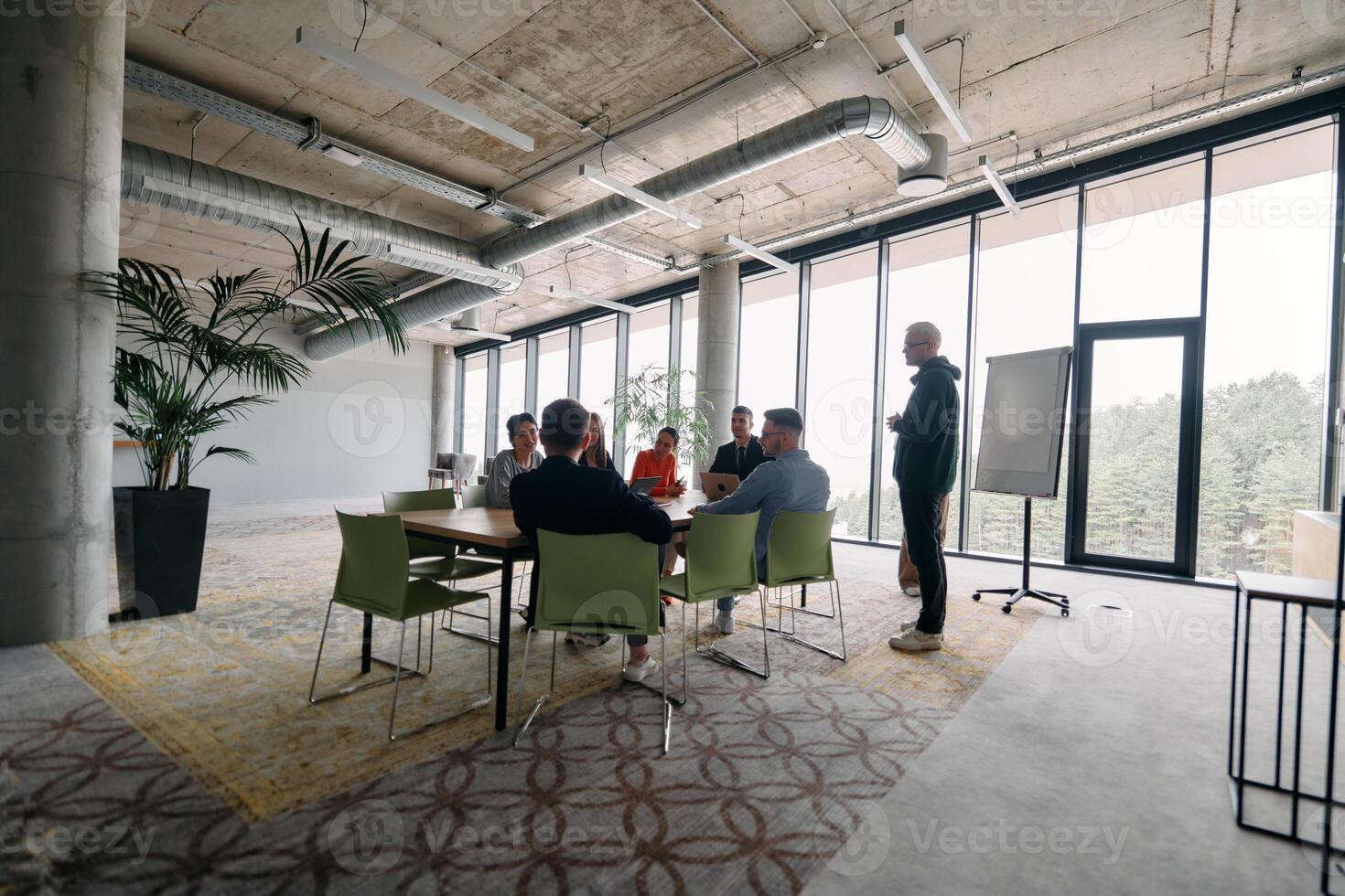 A diverse multiethnic business team engages in a collaborative meeting, discussing strategies and solutions in a modern office setting photo