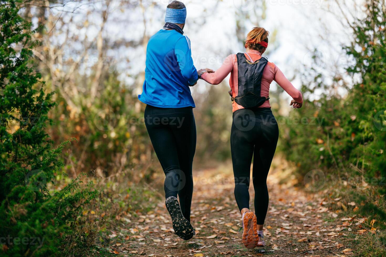 Happy Couple Running on a Forest Trail photo