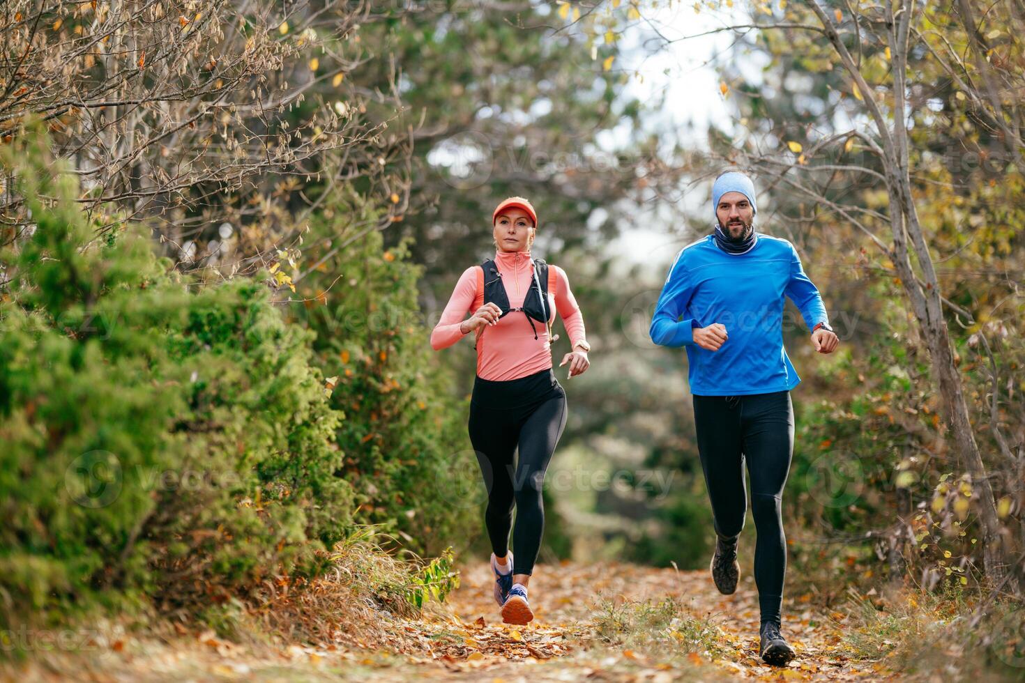 Happy Couple Running on a Forest Trail photo