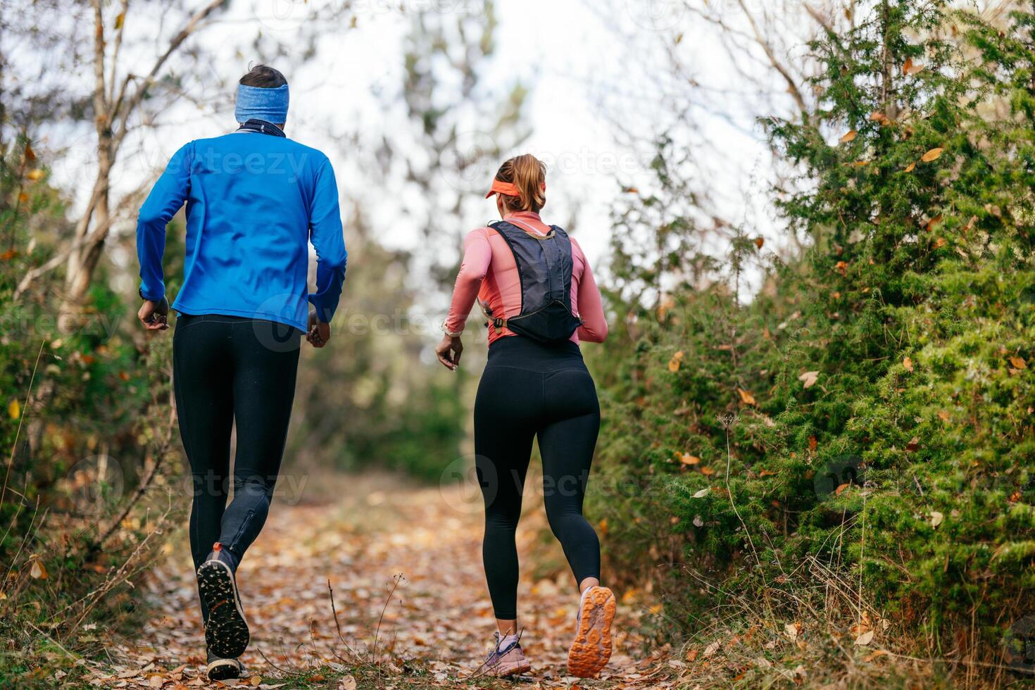 Happy Couple Running on a Forest Trail photo