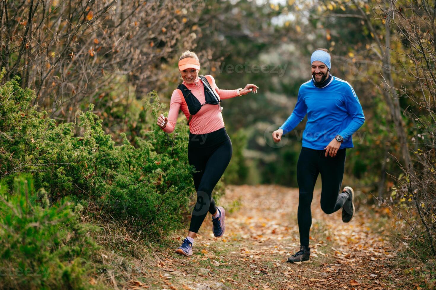Happy Couple Running on a Forest Trail photo