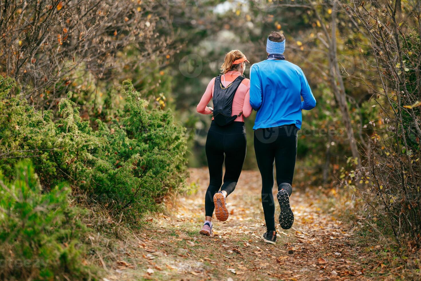 Happy Couple Running on a Forest Trail photo