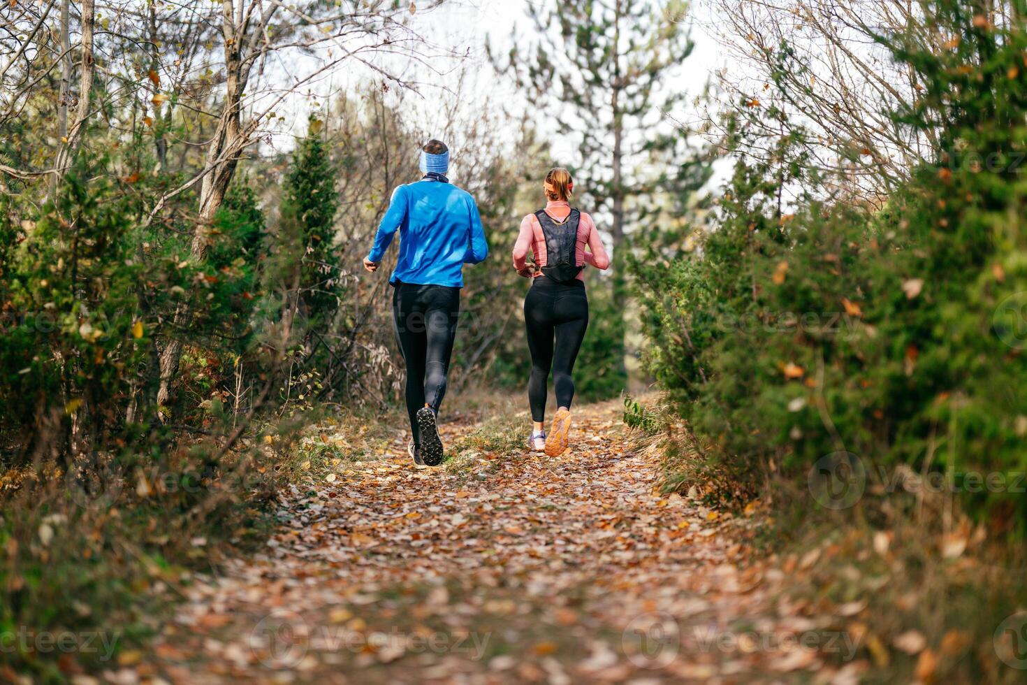 Happy Couple Running on a Forest Trail photo