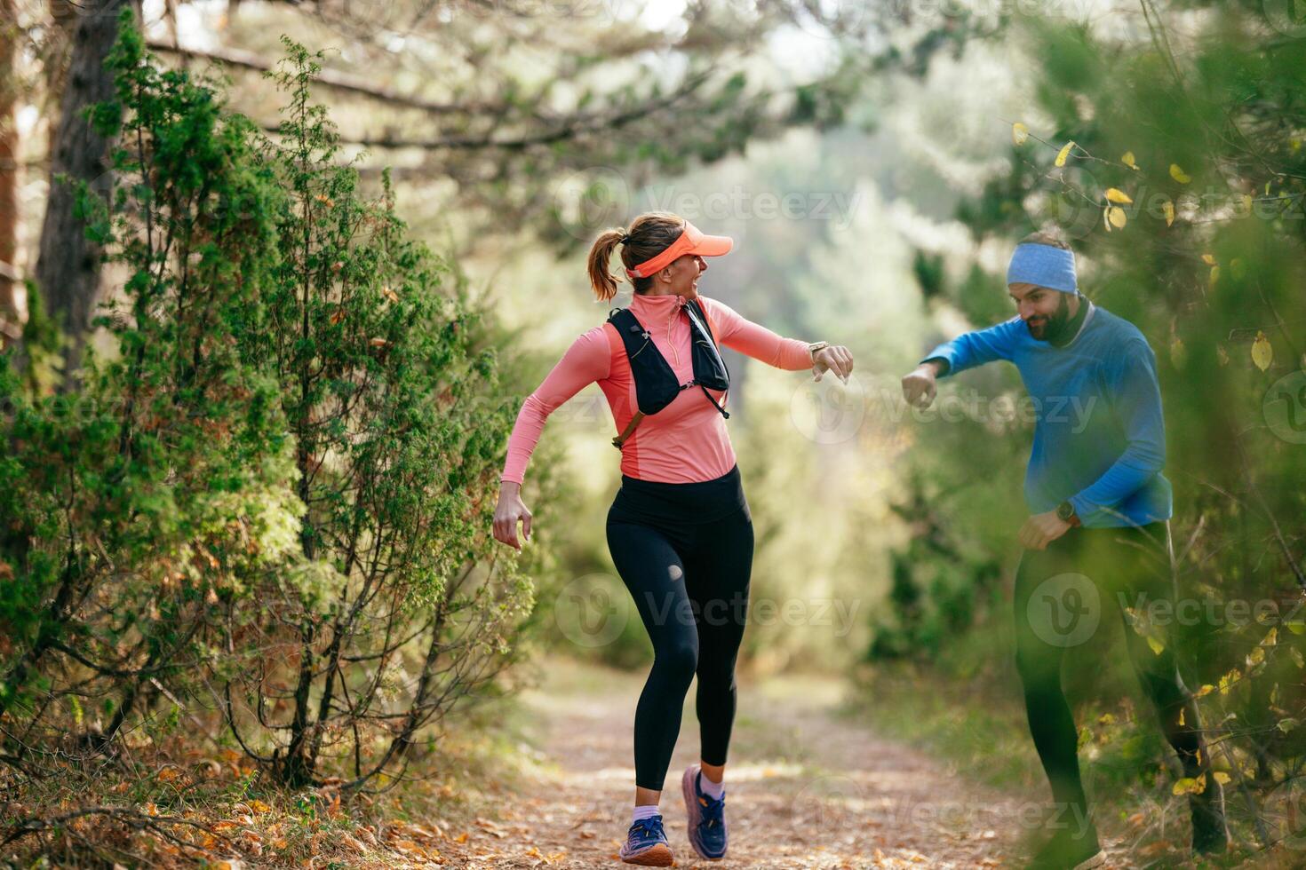 Happy Couple Running on a Forest Trail photo