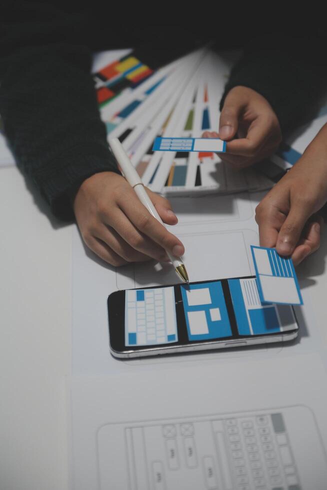 A person is using a phone to design a website photo