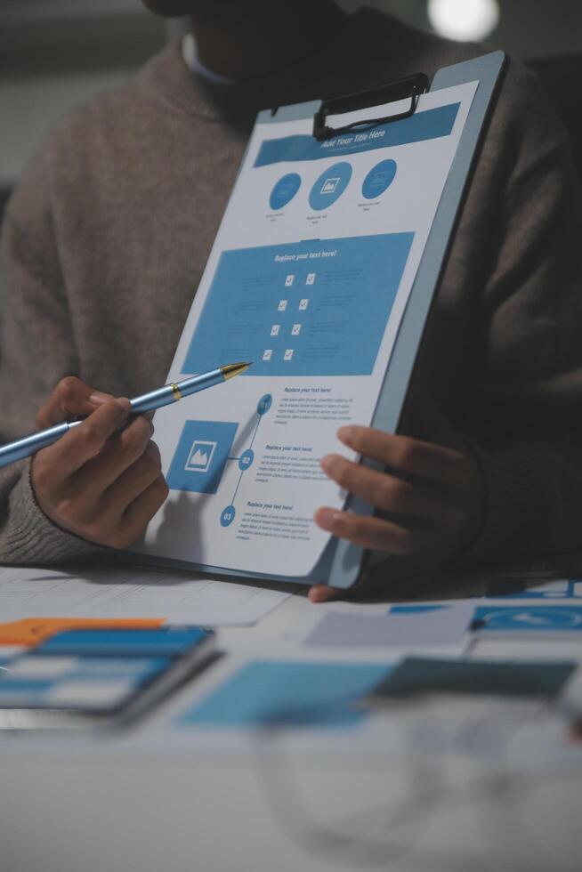 A man is holding a clipboard with a blue and white design on it photo