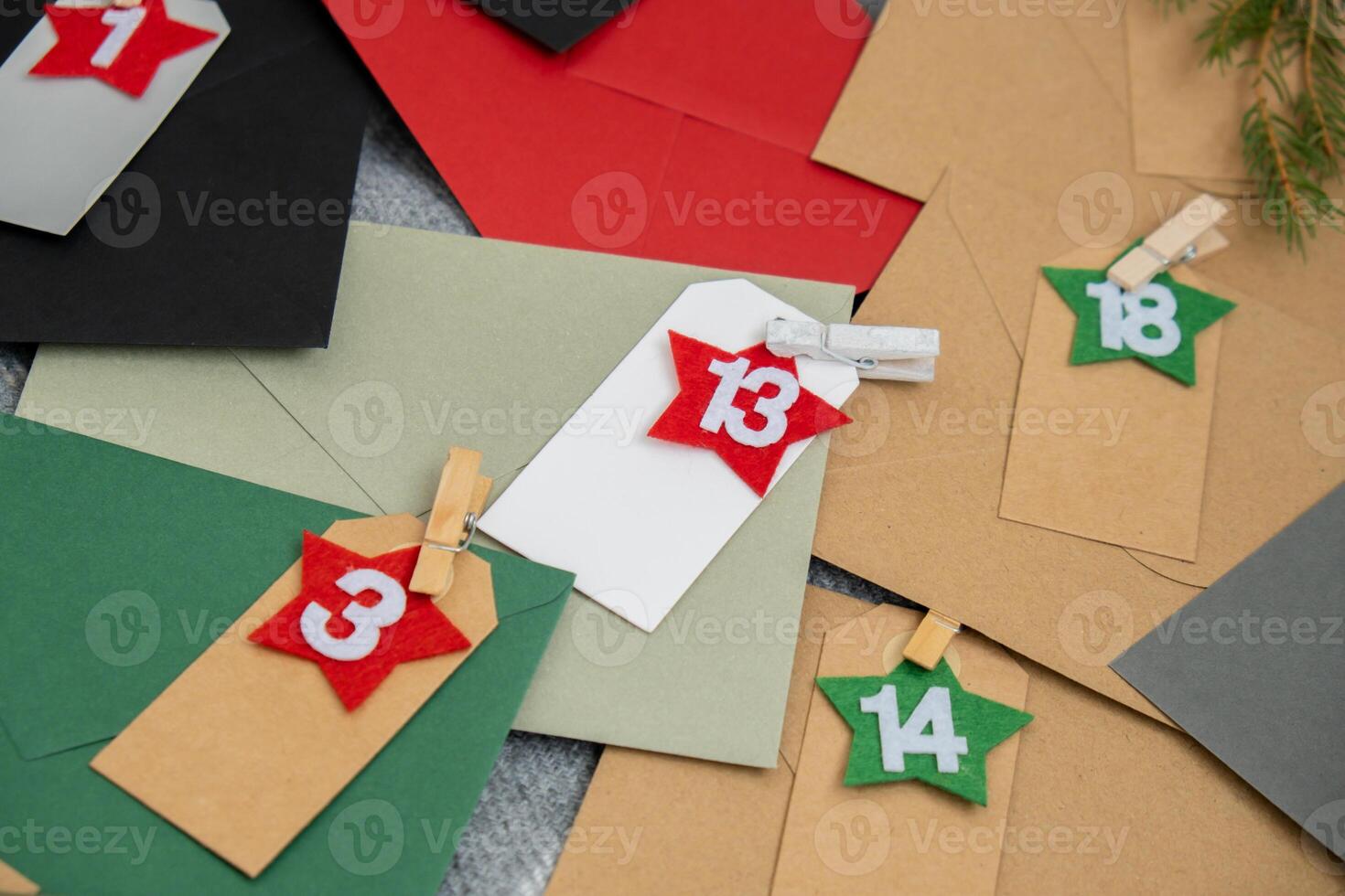 Traditional twenty four days advent calendar before Christmas holidays. Numbers on envelopes Plastic free zero waste sustainable decoration. Winter cozy home Catholic traditions of Christmas countdown new year. Holiday preparation photo