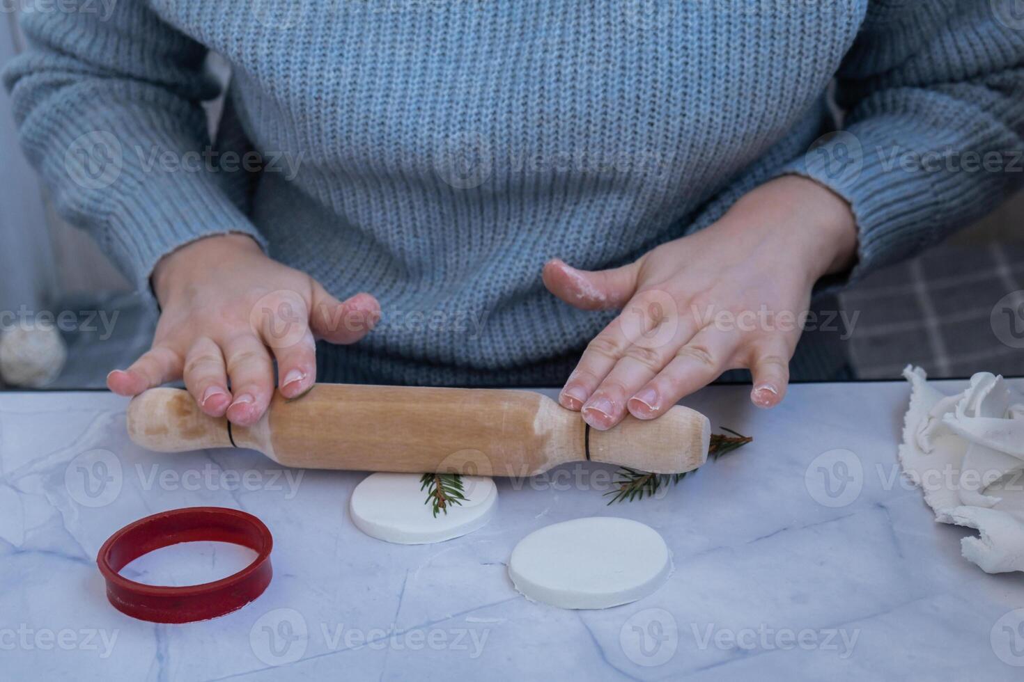 Creator is using white air dry clay for making decor to Christmas tree holiday. Creating hobby recreation activity that involves fingers. DIY crafting Modern art photo