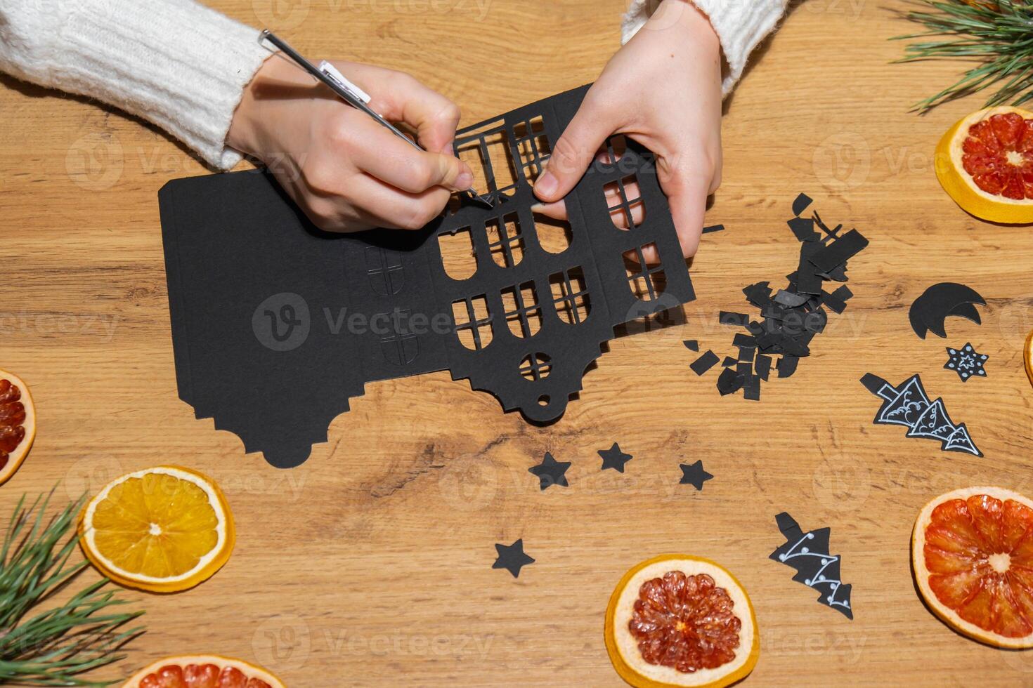 Gingerbread paper house handmade Storytelling creating craft Christmas holiday decoration. Tactile hand-on activity. Master class progress of creative me-made gifts. Seasonal domestic life micro moment hobby. Sustainable living photo