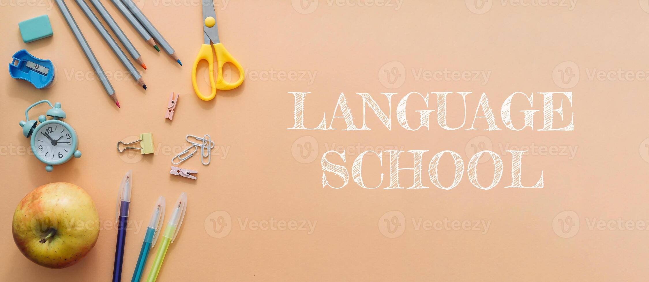 A banner for a language school with a variety of school supplies and a clock photo