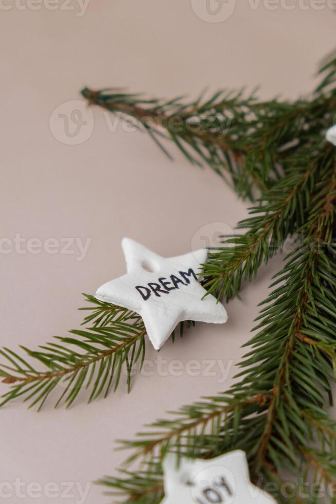 Christmas star with word DREAM White air dry clay for making decor to Christmas tree holiday. Creating hobby recreation activity that involves fingers. DIY crafting Modern art photo