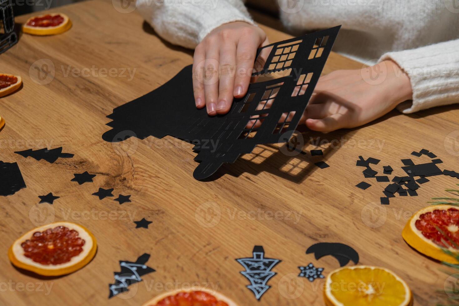 Gingerbread paper house handmade Storytelling creating craft Christmas holiday decoration. Tactile hand-on activity. Master class progress of creative me-made gifts. Seasonal domestic life micro moment hobby. Sustainable living photo