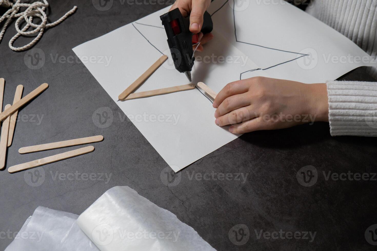 Ice cream sticks Christmas star Sustainable preparation Diy process making handmade decoration. Step by step activity for children. Inclusive and responsible stress relief holiday hobby. Conscious celebration photo
