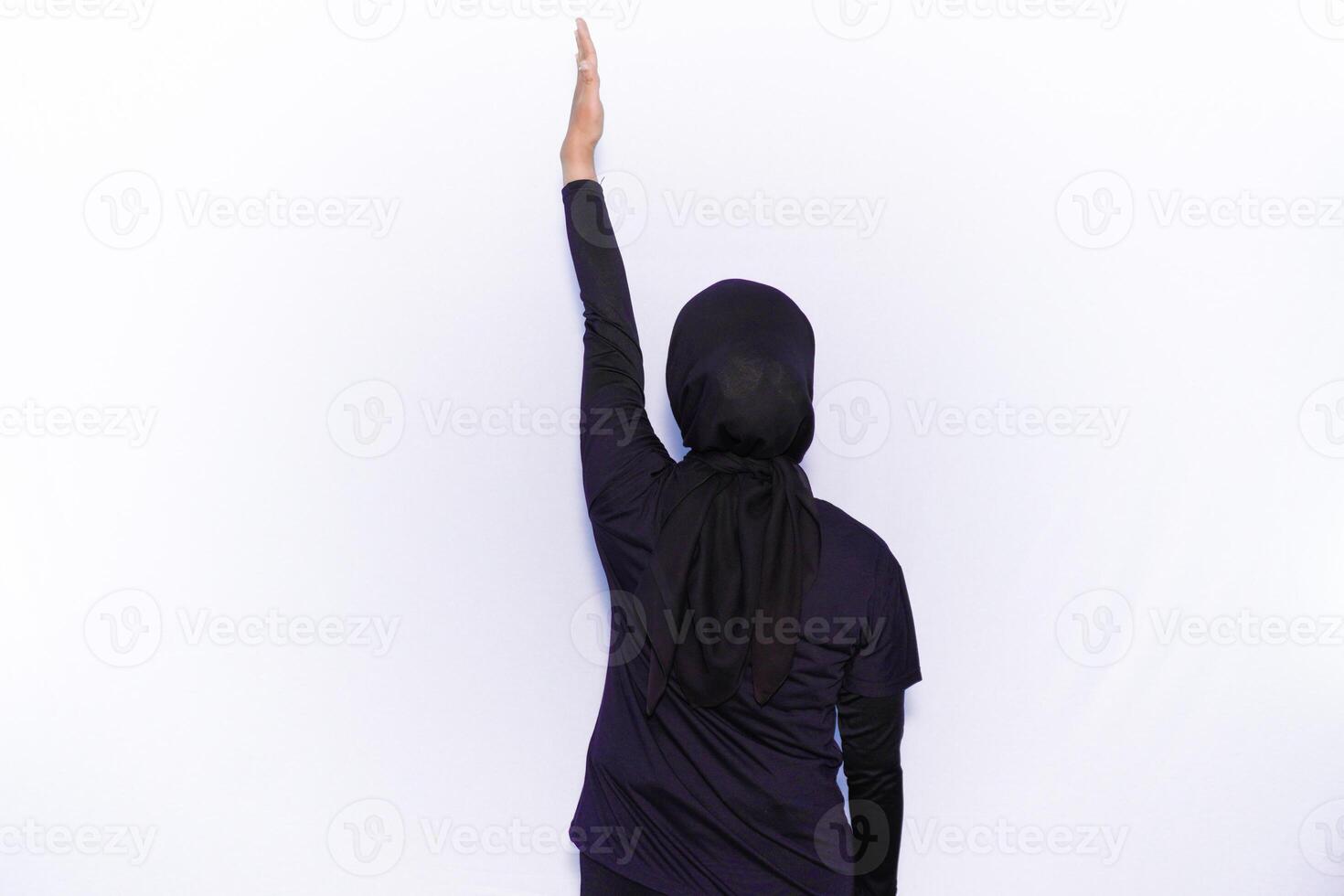 a woman in a black outfit is reaching up photo