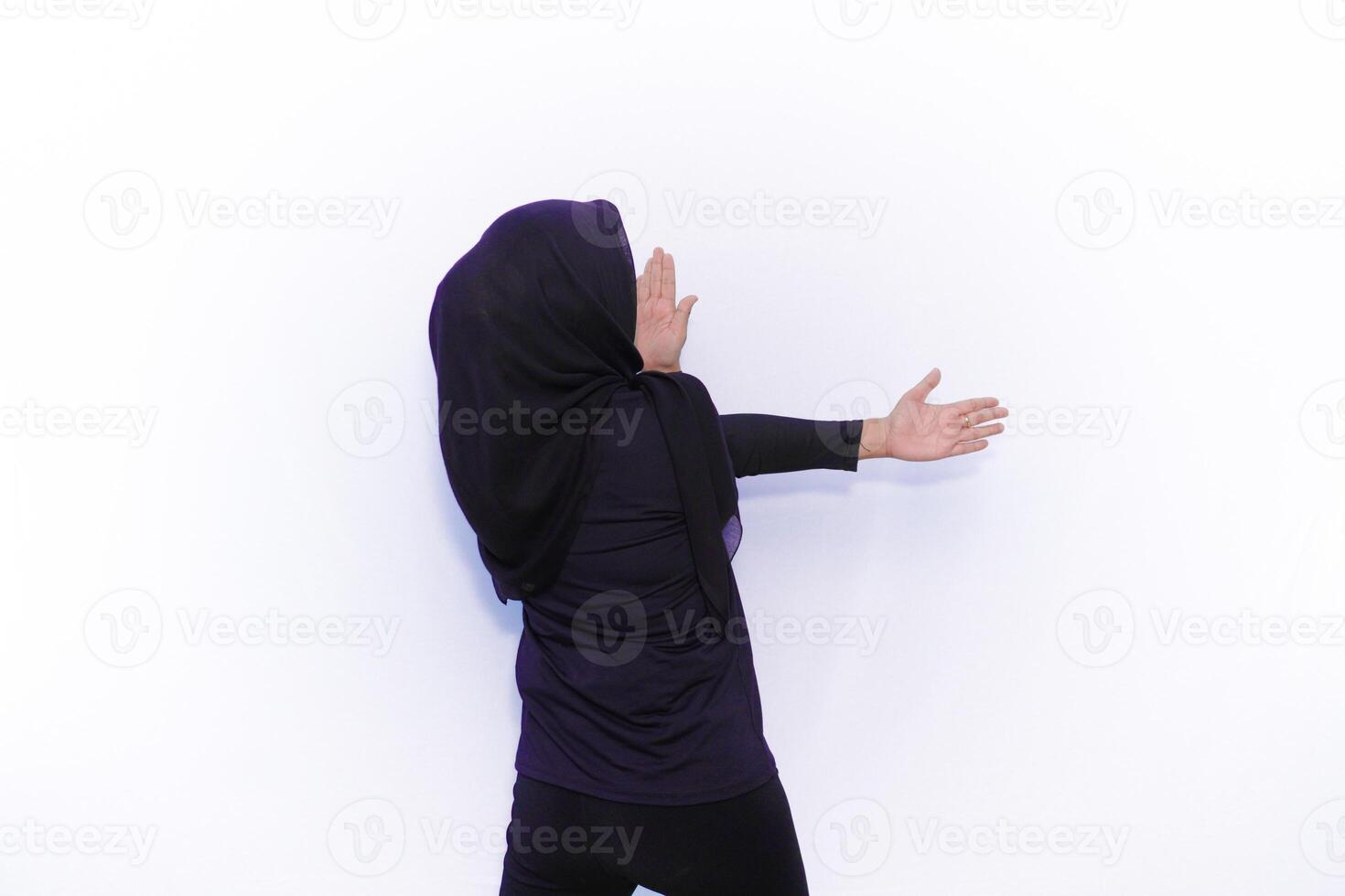 muslim woman in black hijab standing on white background photo